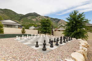 View of backyard play space featuring life-size Chess board, xeriscaping, and a mountain view