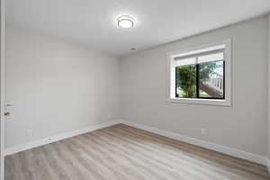 Unfurnished bedroom featuring LVP flooring and daylight windows