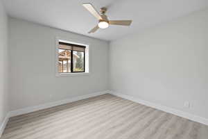Unfurnished bedroom featuring LVP flooring, daylight window, and ceiling fan