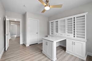 Spare bedroom featuring moveable cabinetry and craft storage