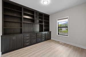 Home office space featuring dark wood cabinetry and LVP flooring