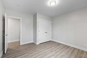 Unfurnished bedroom with LVP flooring