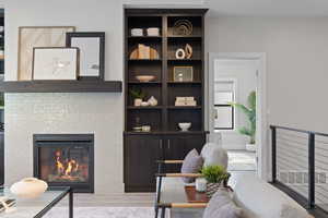 Living area with a tile surround fireplace, built-in cabinetry, LVP flooring, recessed lighting, and natural light.
