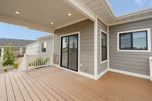 View of covered Trex deck featuring gas line for a BBQ grill