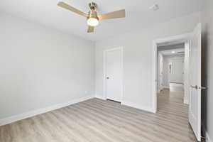 Unfurnished bedroom with LVP flooring and ceiling fan