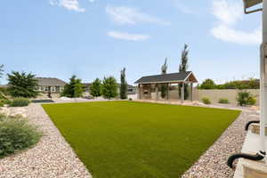 View of backyard featuring custom Timber pergola with fireplace and outdoor lighting, over a Flagstone patio