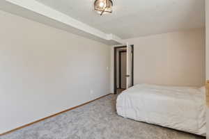 Bedroom featuring carpet flooring and baseboards