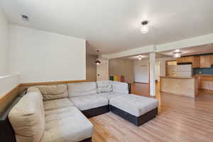 Living area featuring light wood-style flooring and baseboards