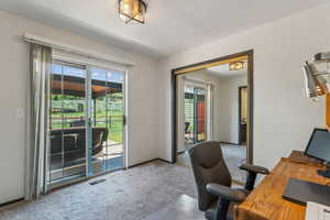Office with carpet flooring and baseboards