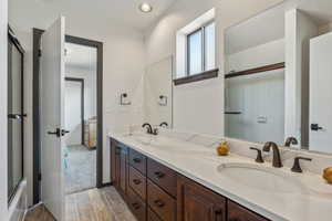 Bathroom featuring wood finished floors and double vanity