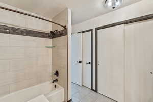 Bathroom with shower / bath combination and tile patterned floors
