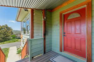 Doorway to property featuring a porch