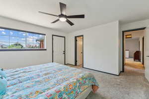 Bedroom featuring light colored carpet and ceiling fan