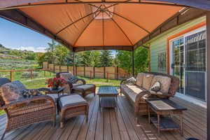 Wooden terrace with outdoor lounge area and a gazebo