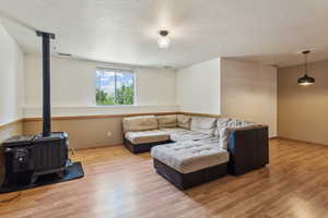 Living area featuring a wood stove and wood finished floors