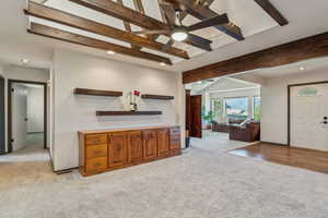 Bar area featuring light colored carpet, beamed ceiling, ceiling fan, recessed lighting, and baseboards