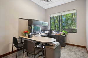 Office area featuring baseboards and a paneled ceiling