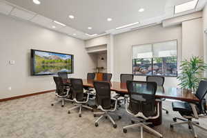 Carpeted home office with recessed lighting and baseboards