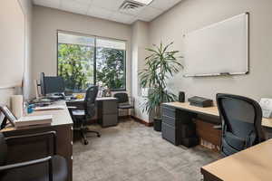Home office featuring light colored carpet and a drop ceiling
