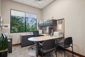 Office featuring baseboards and a paneled ceiling