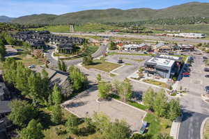 Aerial view of property's location featuring mountains and nearby suburban area