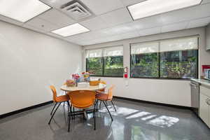 Dining space with baseboards and a paneled ceiling