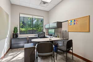 Home office featuring a paneled ceiling and baseboards