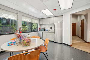 Dining area with baseboards and a drop ceiling