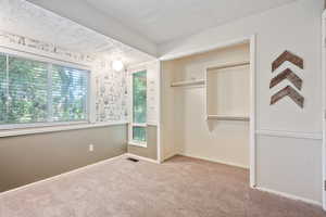Unfurnished bedroom featuring carpet, a closet, and baseboards