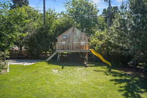 View of green lawn featuring a playground