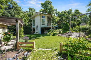 View of green lawn featuring stairs and a pergola