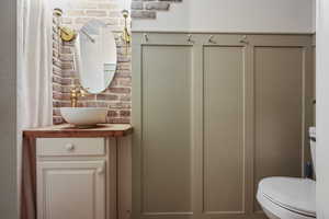 Bathroom featuring vanity and toilet