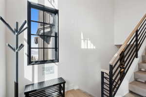Staircase featuring wood finished floors