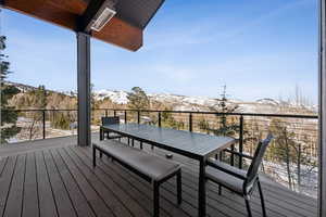 Deck with a mountain view and outdoor dining space
