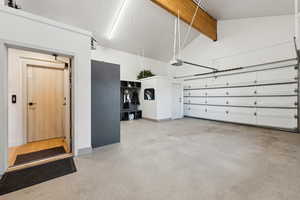 Garage with a garage door opener and baseboards