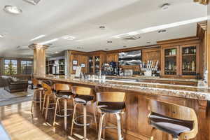 Community bar area featuring ornate columns and wood finished floors