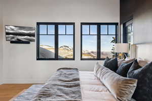 Bedroom with wood finished floors and baseboards