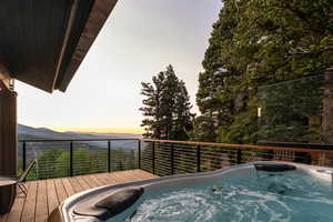 Deck at dusk featuring a mountain view