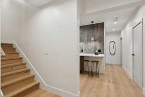 Stairway with wood finished floors and baseboards