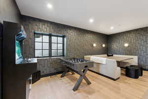 Playroom featuring light wood-style floors, recessed lighting, and wallpapered walls