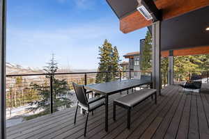 Wooden deck featuring outdoor dining space and a mountain view