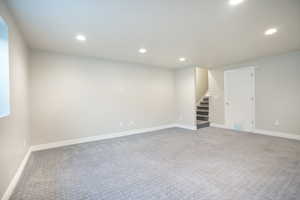 Finished basement featuring stairway, carpet, recessed lighting, and baseboards