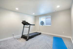 Workout area with carpet floors, baseboards, and recessed lighting