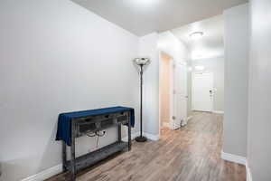 Hall featuring wood finished floors and baseboards