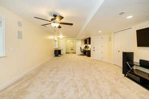 Unfurnished living room with light colored carpet, ceiling fan, recessed lighting, and baseboards