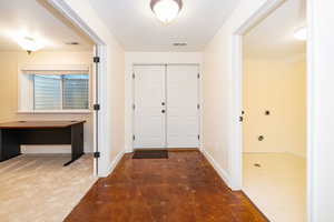 Foyer entrance featuring baseboards and concrete flooring