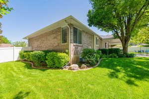 View of home's exterior with brick siding and a patio area