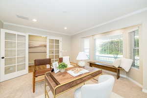 Home office or formal living room with french doors, light carpet, crown molding, baseboards, and recessed lighting