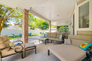 Fenced backyard featuring an outdoor hangout area, a patio, and outdoor dining area