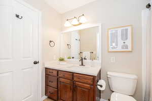 Bathroom featuring vanity and toilet